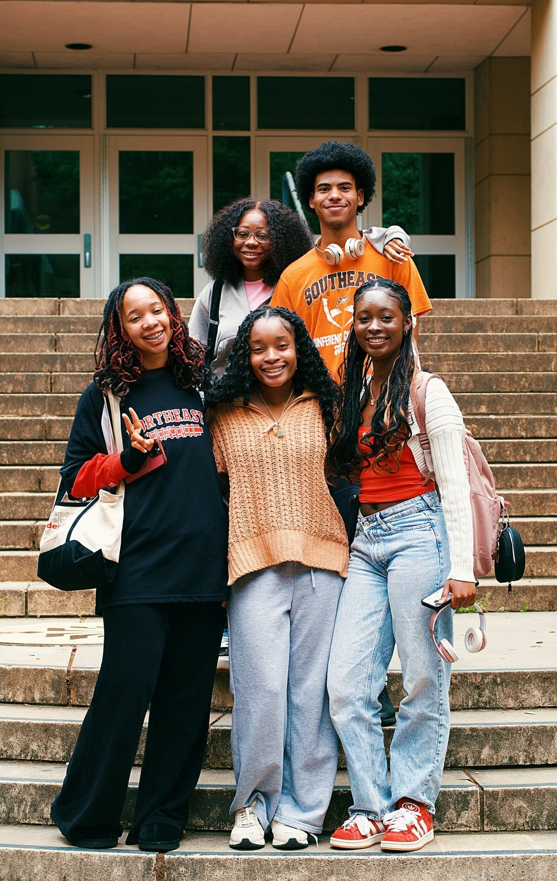Groupe de jeunes amis souriants sur des marches